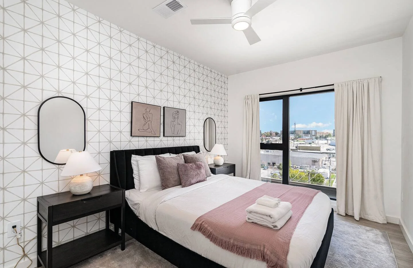 Queen bedroom with geometric accent wall