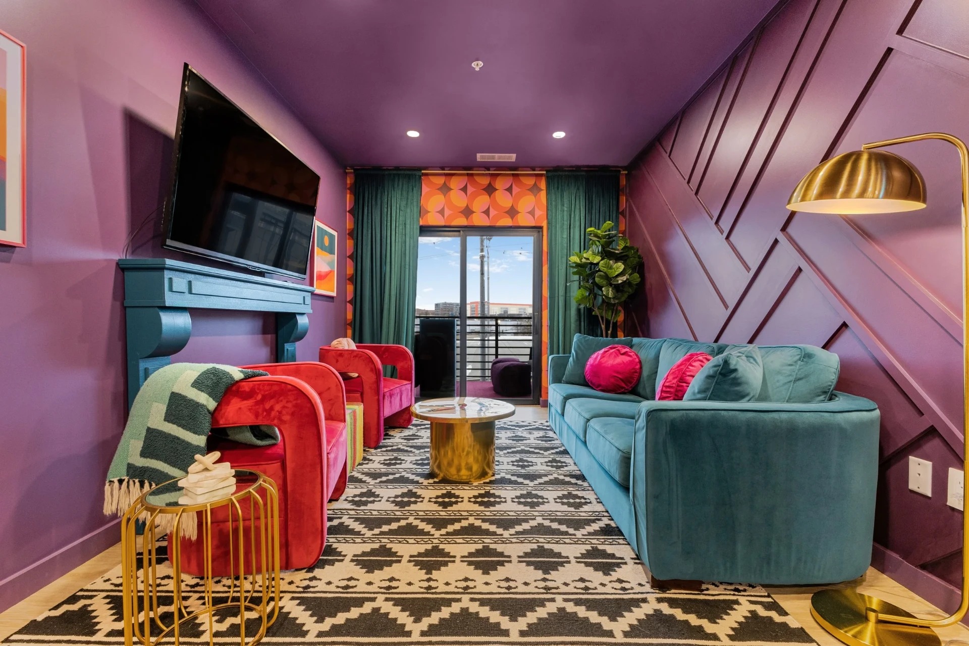 Lounge with teal fireplace & balcony access