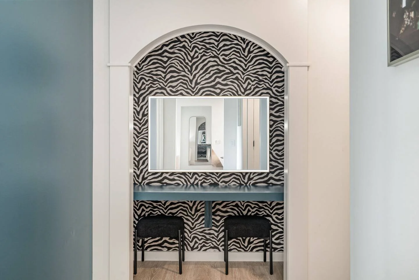 Arched vanity with statement wallpaper